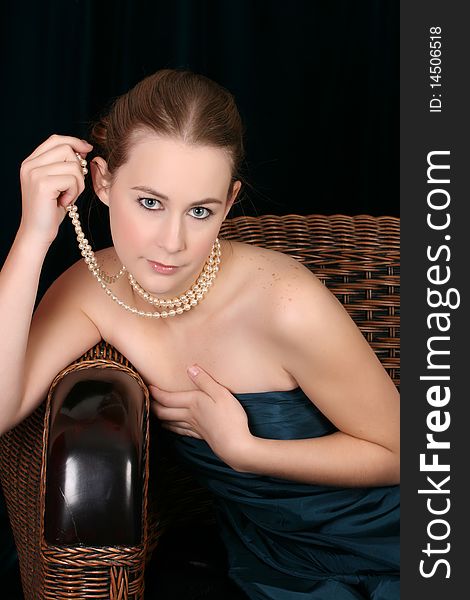Beautiful female wrapped in fabric, wearing pearls