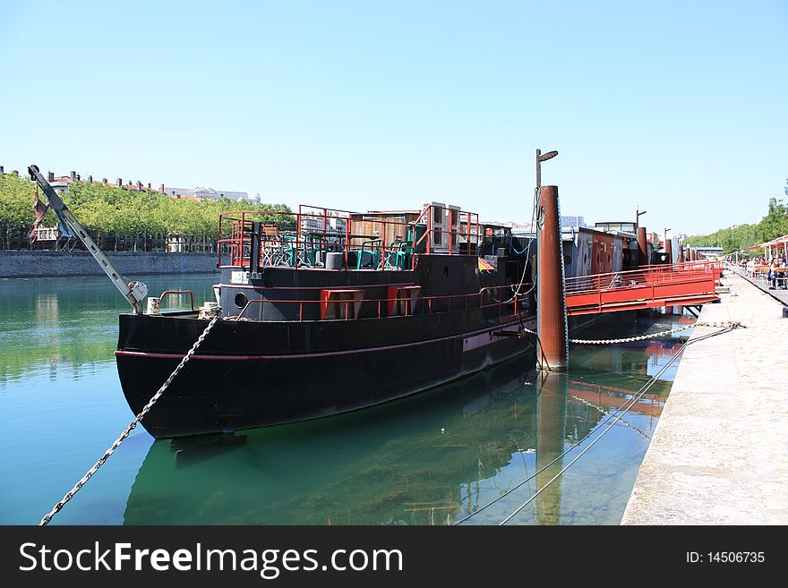 Barge moored on the dock Saone - Lyon, France