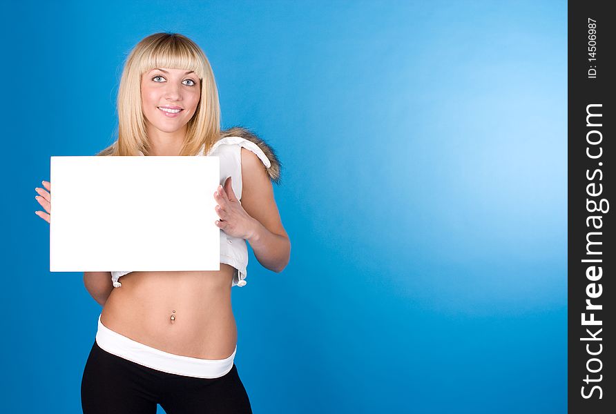 Closeup portrait of cute young woman holding a white page on a blue background. Closeup portrait of cute young woman holding a white page on a blue background