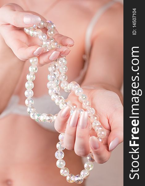 Girl with pearl beads in her hands. Girl with pearl beads in her hands