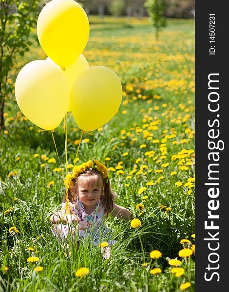Little girl with yellow balloons on dandelion field. Little girl with yellow balloons on dandelion field