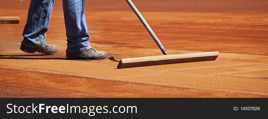 Tennis court preparation close up. Tennis court preparation close up