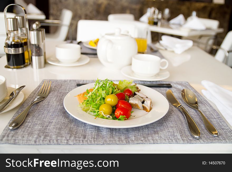 A white dish with fresh salad