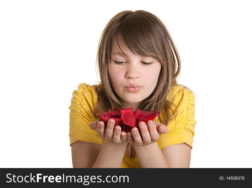 Girl blows on petals lying on palm isolated in white