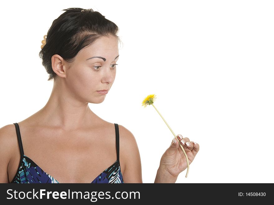 Young woman with surprise looks at flower isolated in white