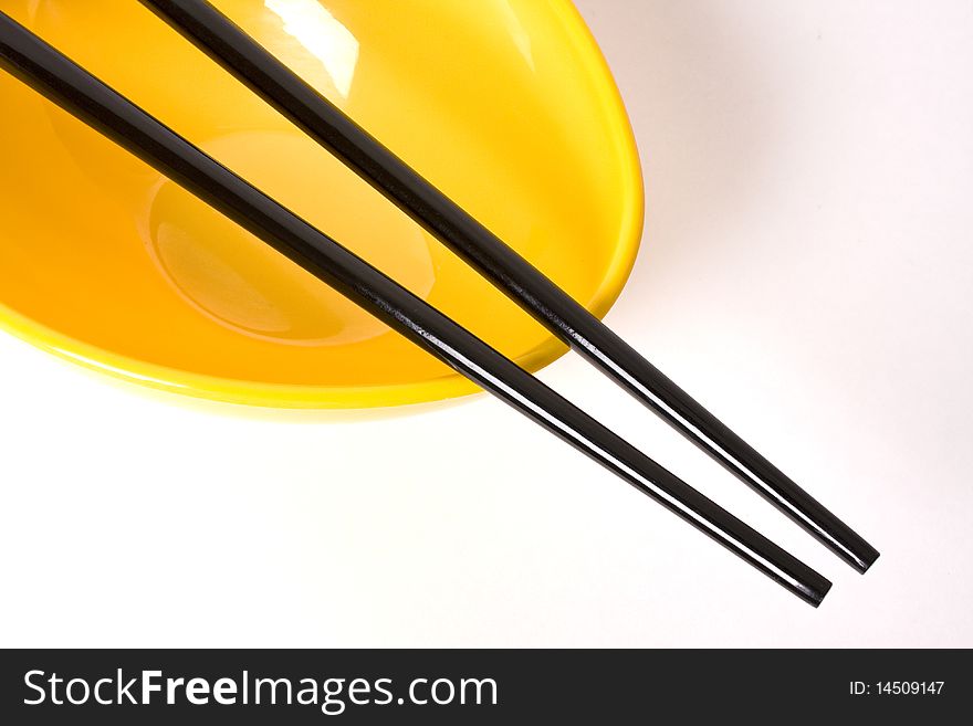 2 back chopsticks placed neatly over an eye catching Yellow colored blow â€¦ a interesting  crop which can be placed in a corner of a design composition. 2 back chopsticks placed neatly over an eye catching Yellow colored blow â€¦ a interesting  crop which can be placed in a corner of a design composition.