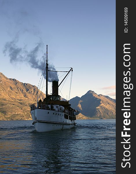 Steamboat in shadow on a lake in Queenstown, New Zealand. Steamboat in shadow on a lake in Queenstown, New Zealand