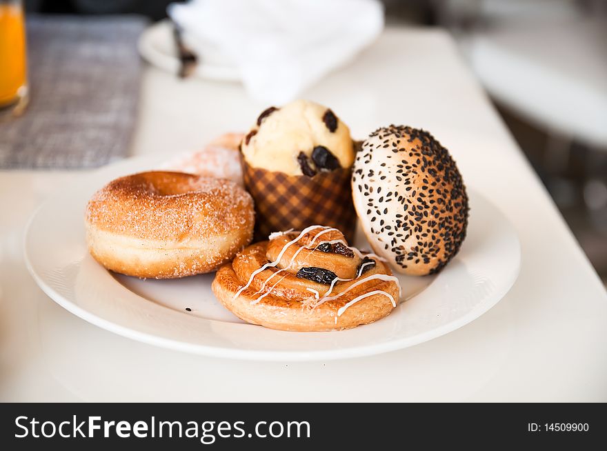 Delicious sweet buns on plate. Delicious sweet buns on plate