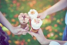 Women Hand Holding An Ice Cream Collide And Happy. The Time Of Relaxation. Stock Photos