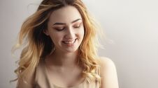 Studio Portrait Of A Beautiful Sincerely Laughing Girl, Young Woman Face With Curly Hair Disheveled From Wind , The Concept Of Royalty Free Stock Photography