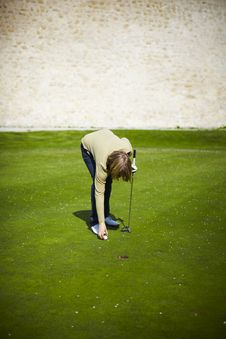 Woman At The Golf Range Preparing Golf Ball Royalty Free Stock Image