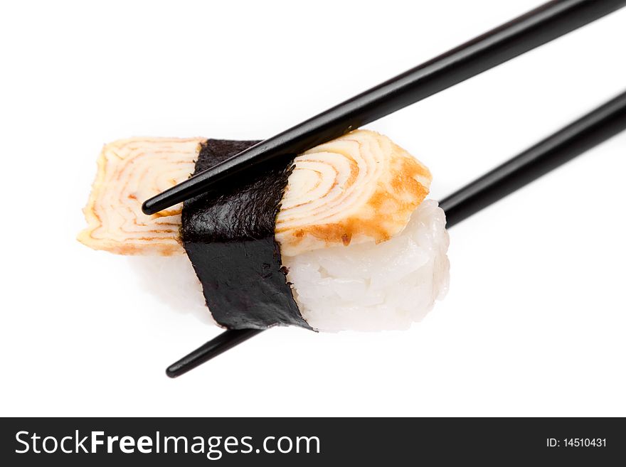 An image of a piece of sushi in black chopsticks. An image of a piece of sushi in black chopsticks