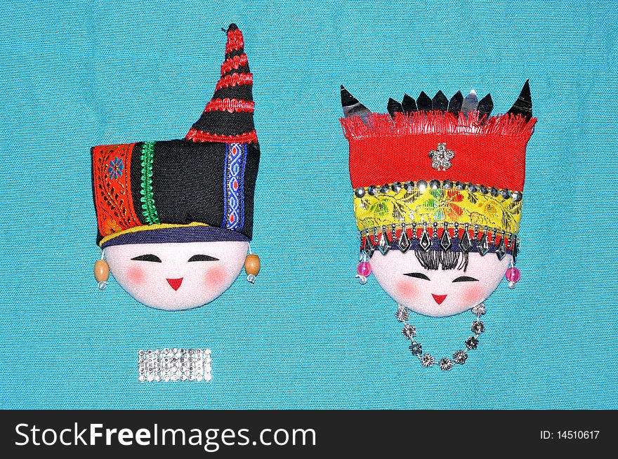 Finery embroidery doll of Chinese minority Chuang's tradtional style. The raiment and hat for men and women in feast day. Finery embroidery doll of Chinese minority Chuang's tradtional style. The raiment and hat for men and women in feast day.