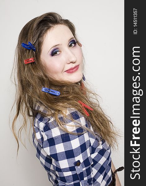 Young pretty woman with clothespin on the hair in studio