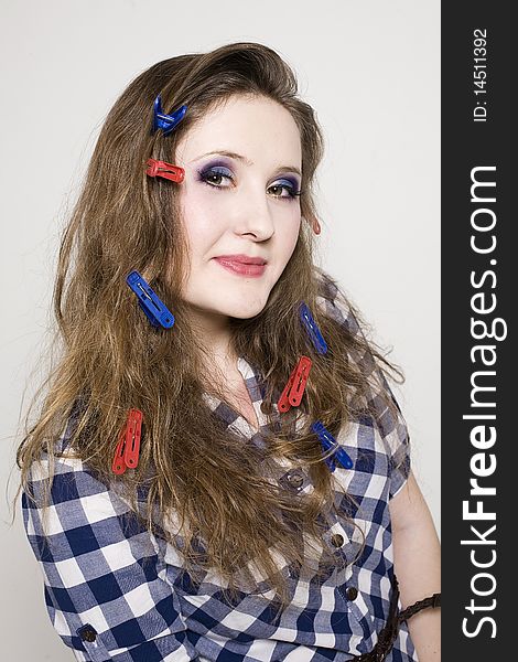 Young pretty woman with clothespin on the hair in studio