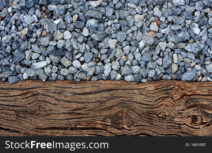 Texture of crashed grey granite gravel background and wood. Texture of crashed grey granite gravel background and wood