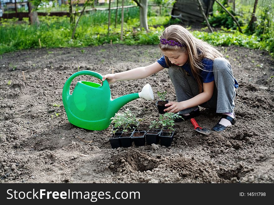 An image of a nice little girl working in the garden. An image of a nice little girl working in the garden