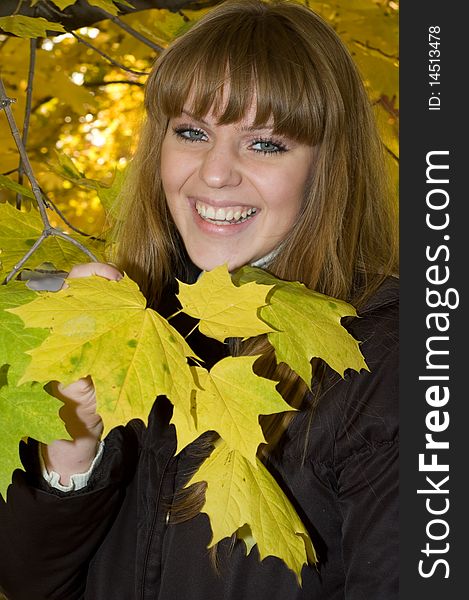 Smiling young girl  in yellow autumn park. Smiling young girl  in yellow autumn park