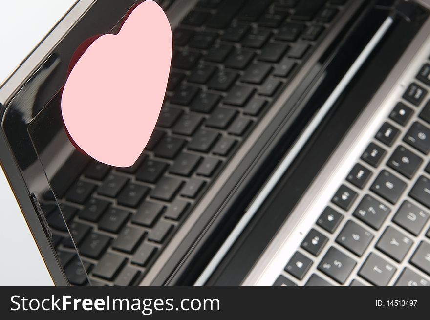 Black laptop screen with pink sticker. Black laptop screen with pink sticker