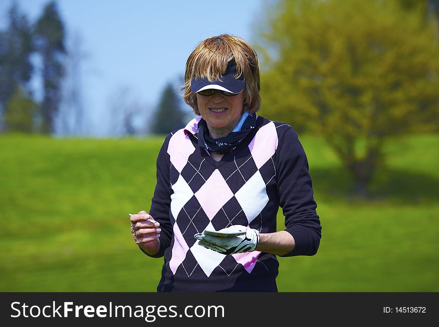 Woman At The Golf Range Writing The Score