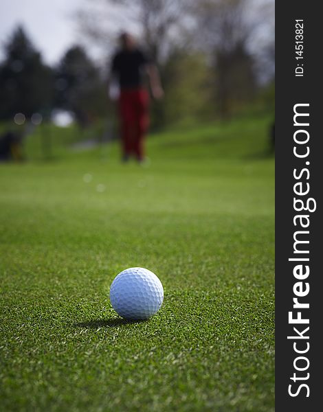 Golf ball close-up with golfer man