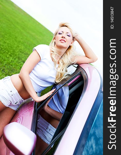 Beautiful young woman with her car outdoor on a summer day. Beautiful young woman with her car outdoor on a summer day
