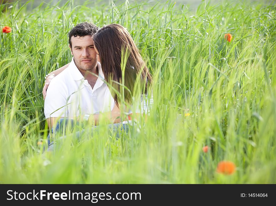 Young couple surrounded by green wheat. Young couple surrounded by green wheat.