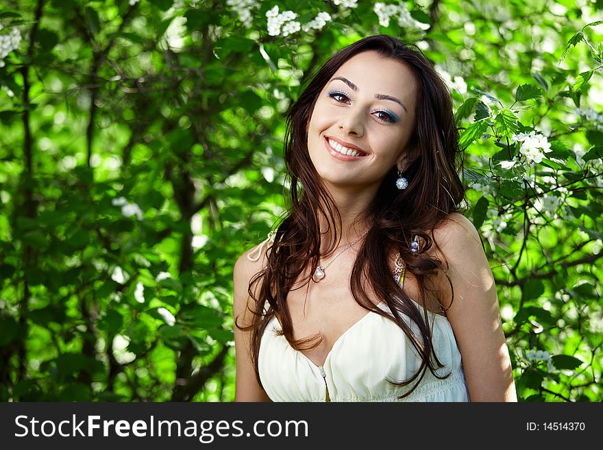 The beautiful girl in greens of trees