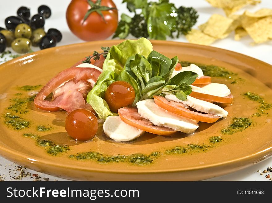 Mozzarella dish with tomato, lettuce and spinach. Mozzarella dish with tomato, lettuce and spinach