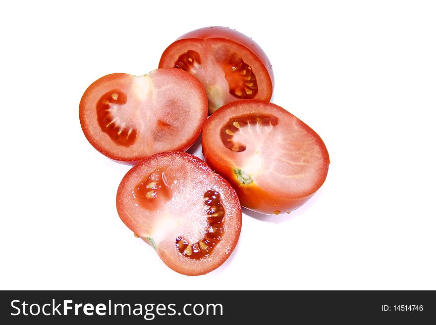 Juicy tomatoes cut in half isolated on a white background