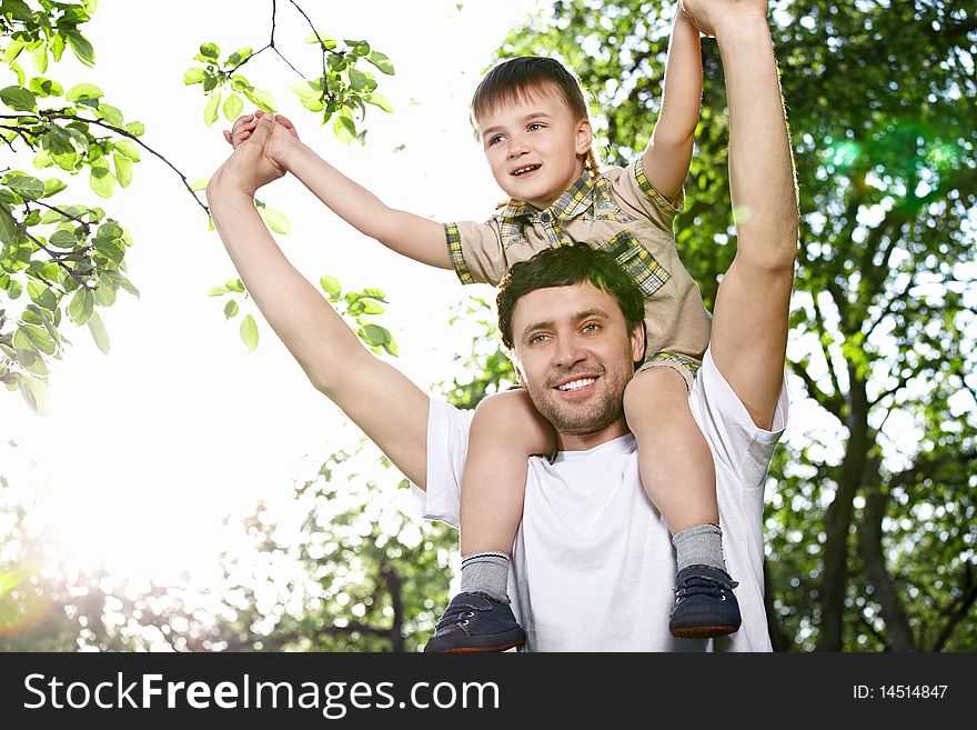 The young man holds on shoulders of the boy. The young man holds on shoulders of the boy