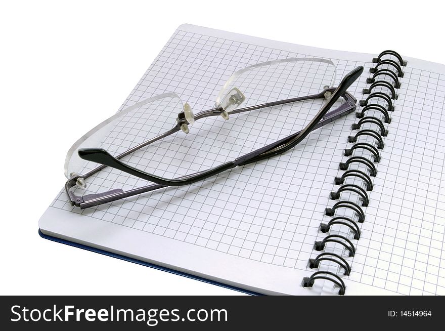 Notepad and glasses (white background)