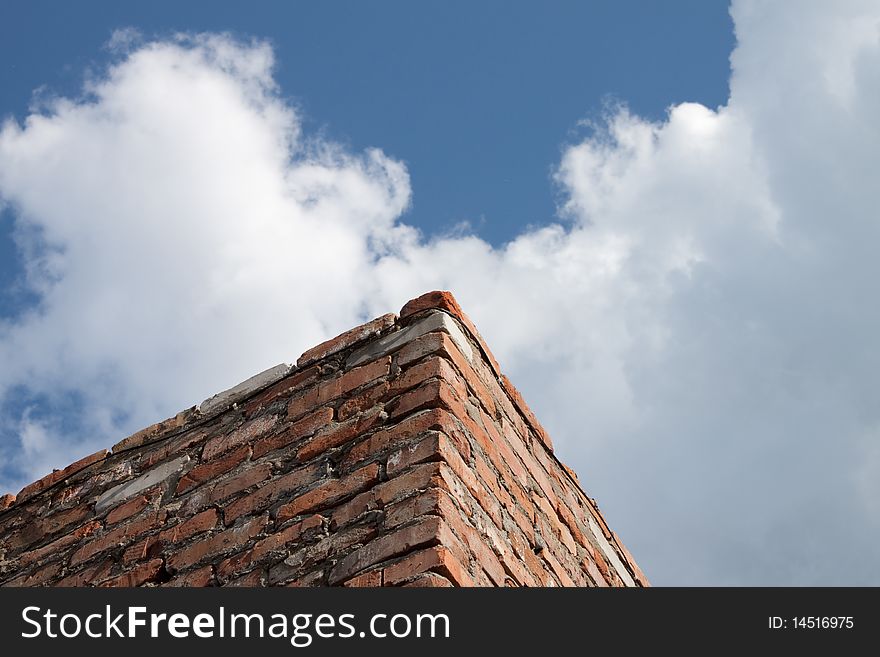 Brick wall against the blue sky