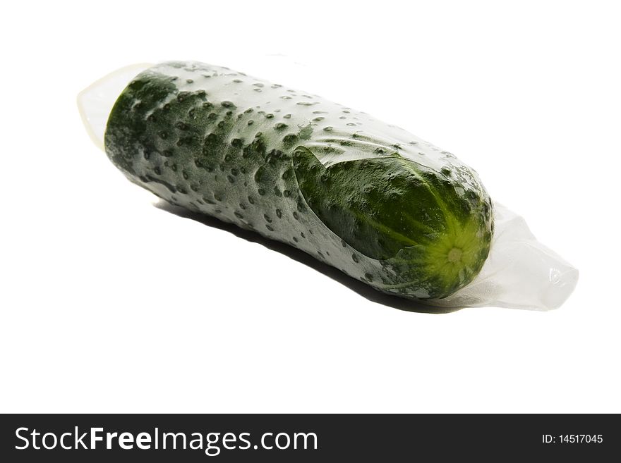 The torn condom on a green cucumber