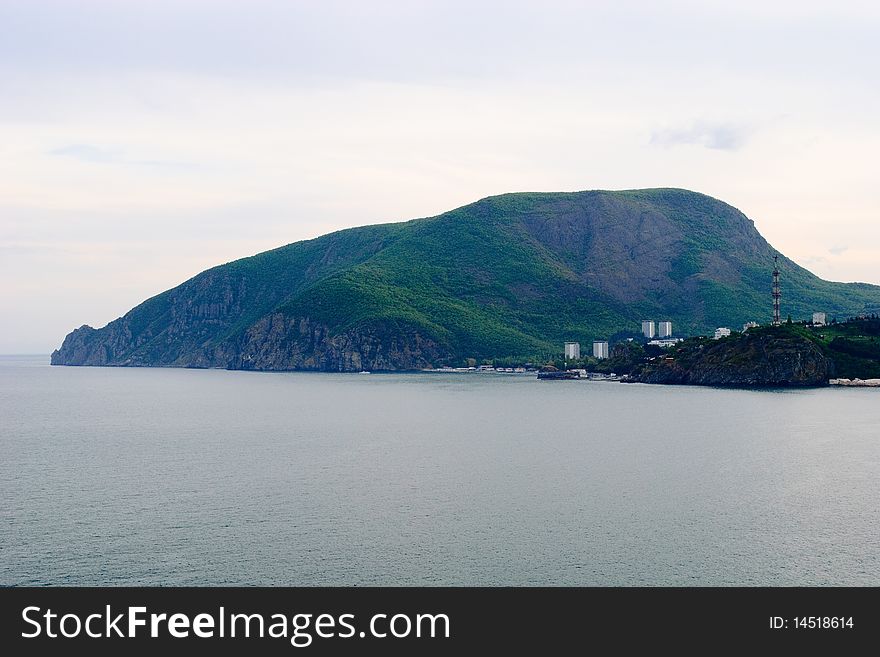 View of the Ayu-Dag mountain and city Partenit from the cap Karasan. View of the Ayu-Dag mountain and city Partenit from the cap Karasan