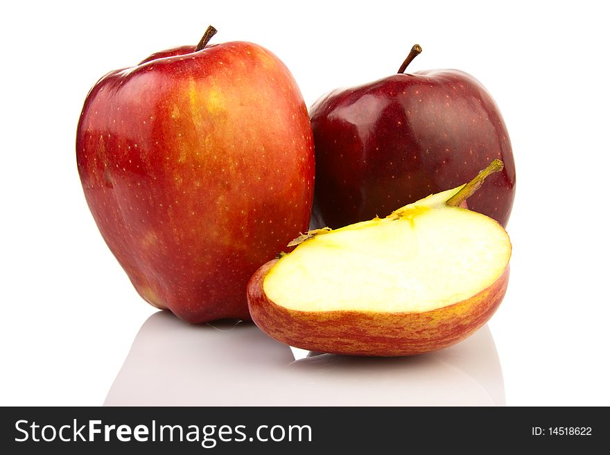 Red ripe apples on the reflecting surface