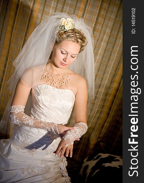 Beautiful bride puts on a white glove