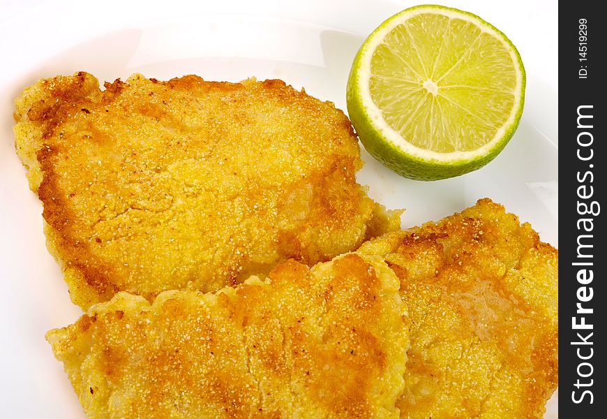 Fish Filet with lemon. Close up on white background