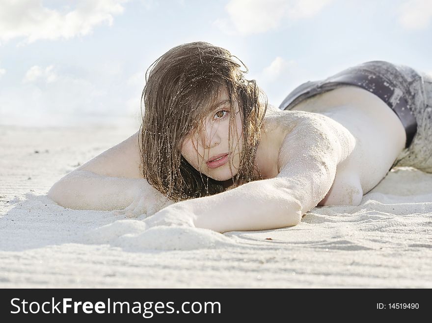 Model Laying On The Sand