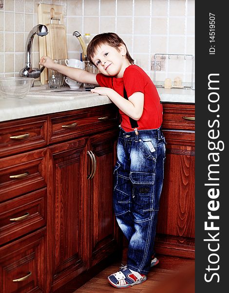 Little boy at a kitchen at home. Little boy at a kitchen at home.