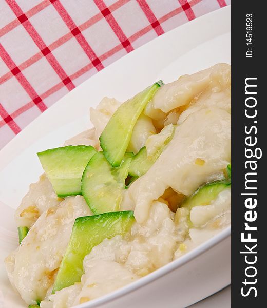 Fried white fish with cucumber. Close up