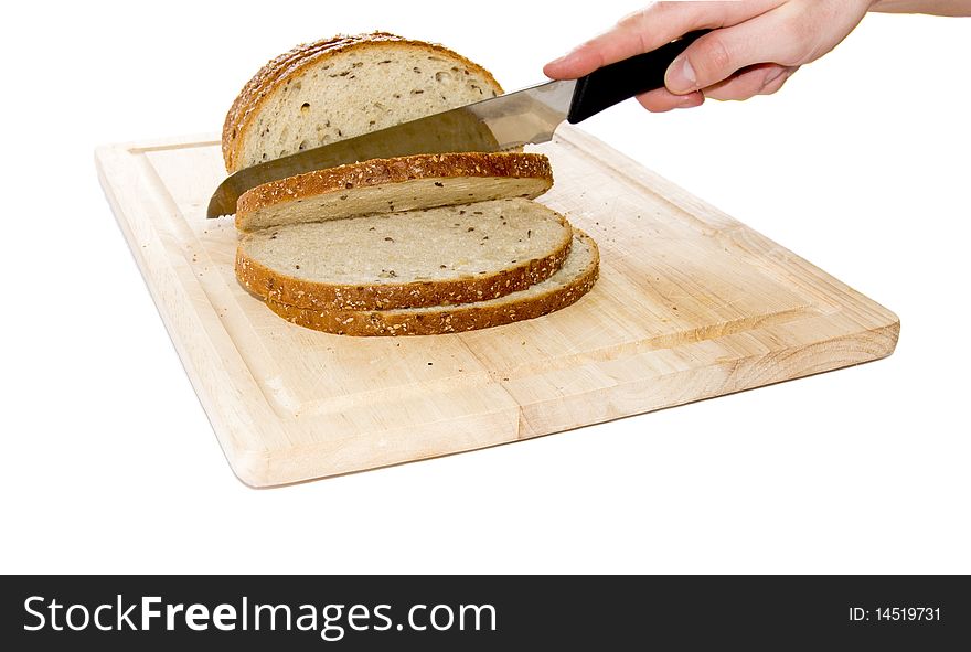 Bread cut by knife on kitchen board