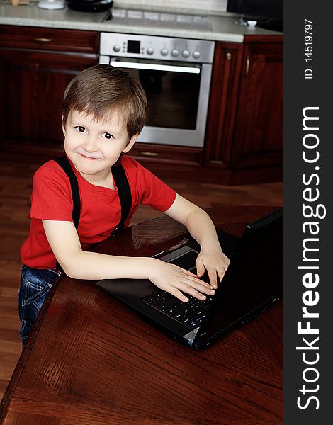 Little boy with his laptop at home. Little boy with his laptop at home.