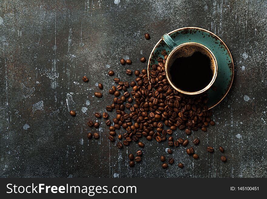 Coffee cup and coffee beans on vintage background, copy space