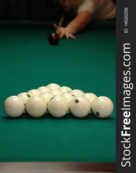 Young girl playing billiards. Competition.