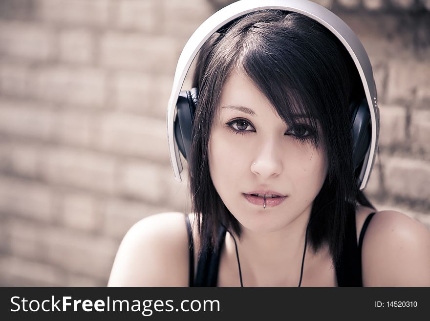 Young beautiful girl portrait wearing headphones. Young beautiful girl portrait wearing headphones.