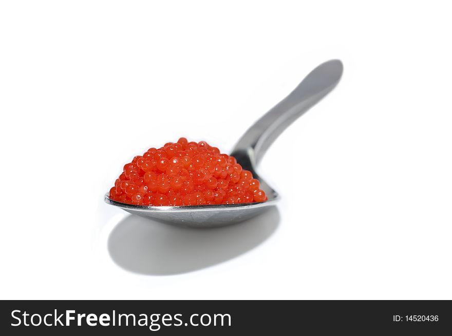 Spoon of red caviar on white background. Spoon of red caviar on white background