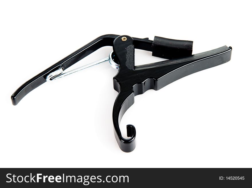 Black 12 string capo on a white background. Black 12 string capo on a white background