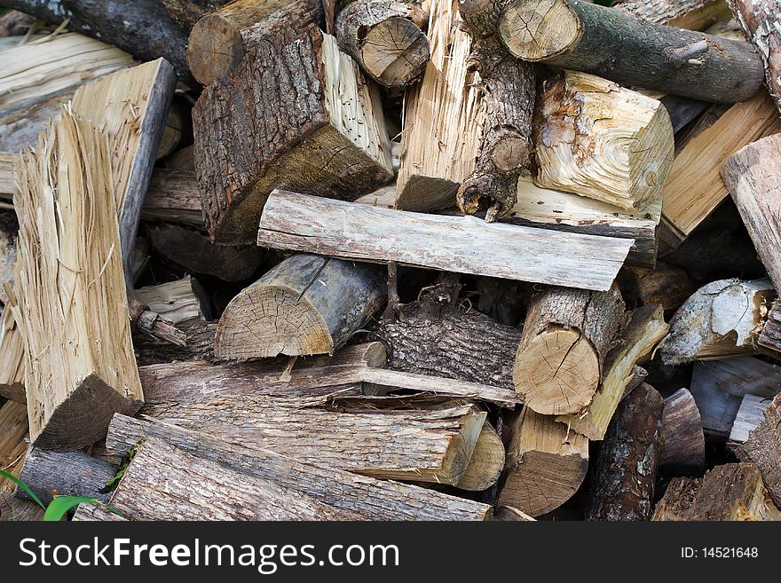 Uncut firewood in an unorganized pile. Uncut firewood in an unorganized pile.