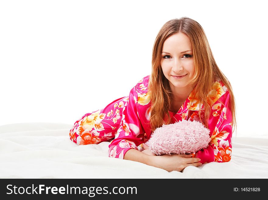 Picture of a sweet young girl in pink pajamas on bed